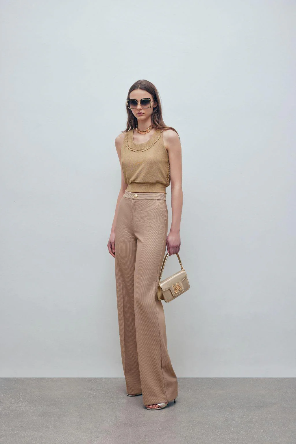 Gold-laminated corduroy trousers